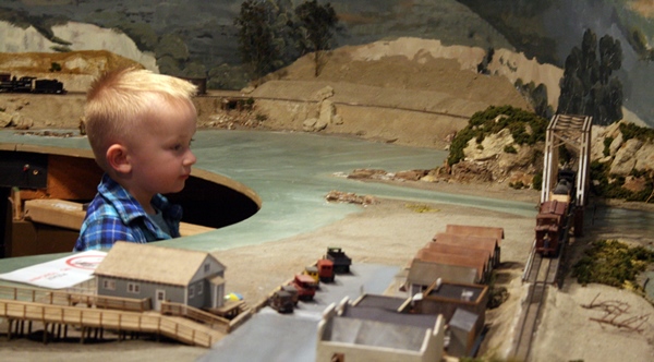 photo of kid looking at model railroad